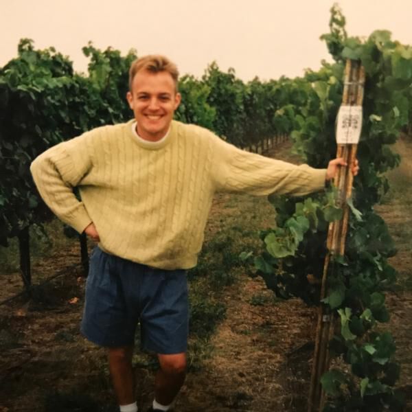Young Greg Brewer in a vineyard